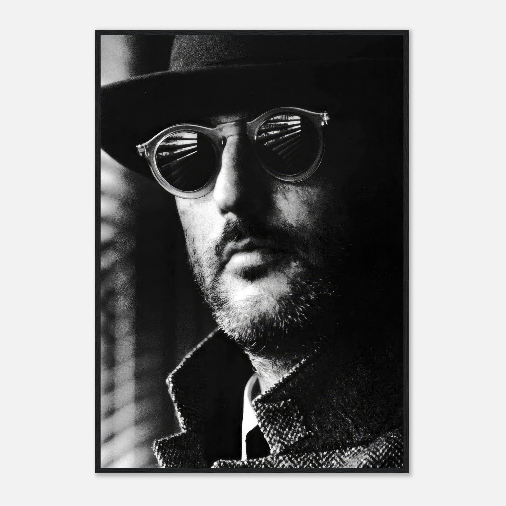 Black-and-white framed print of a man wearing sunglasses and a hat, exuding mystery and elegance.