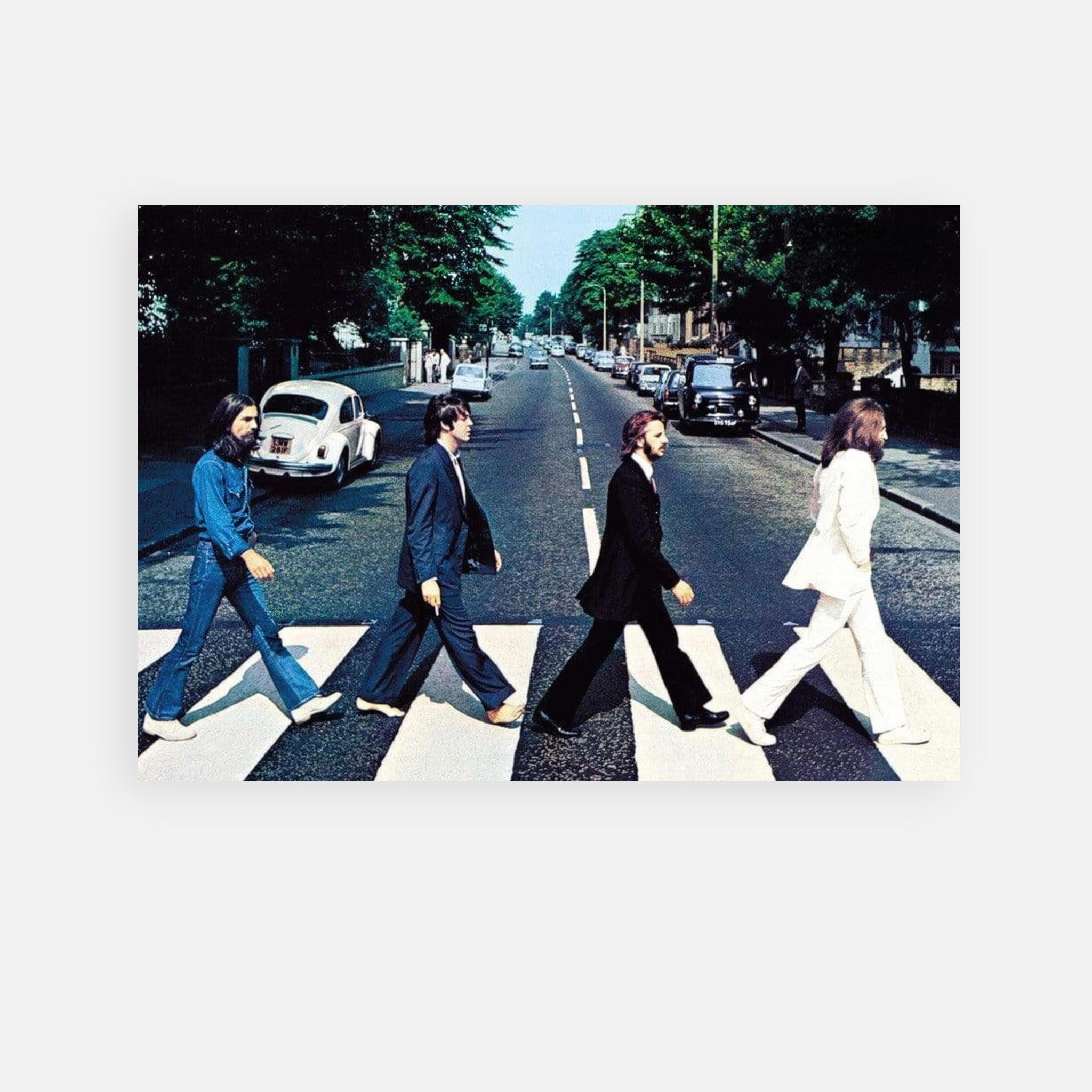 The Beatles crossing Abbey Road, iconic metal print featuring four members on a zebra crossing.