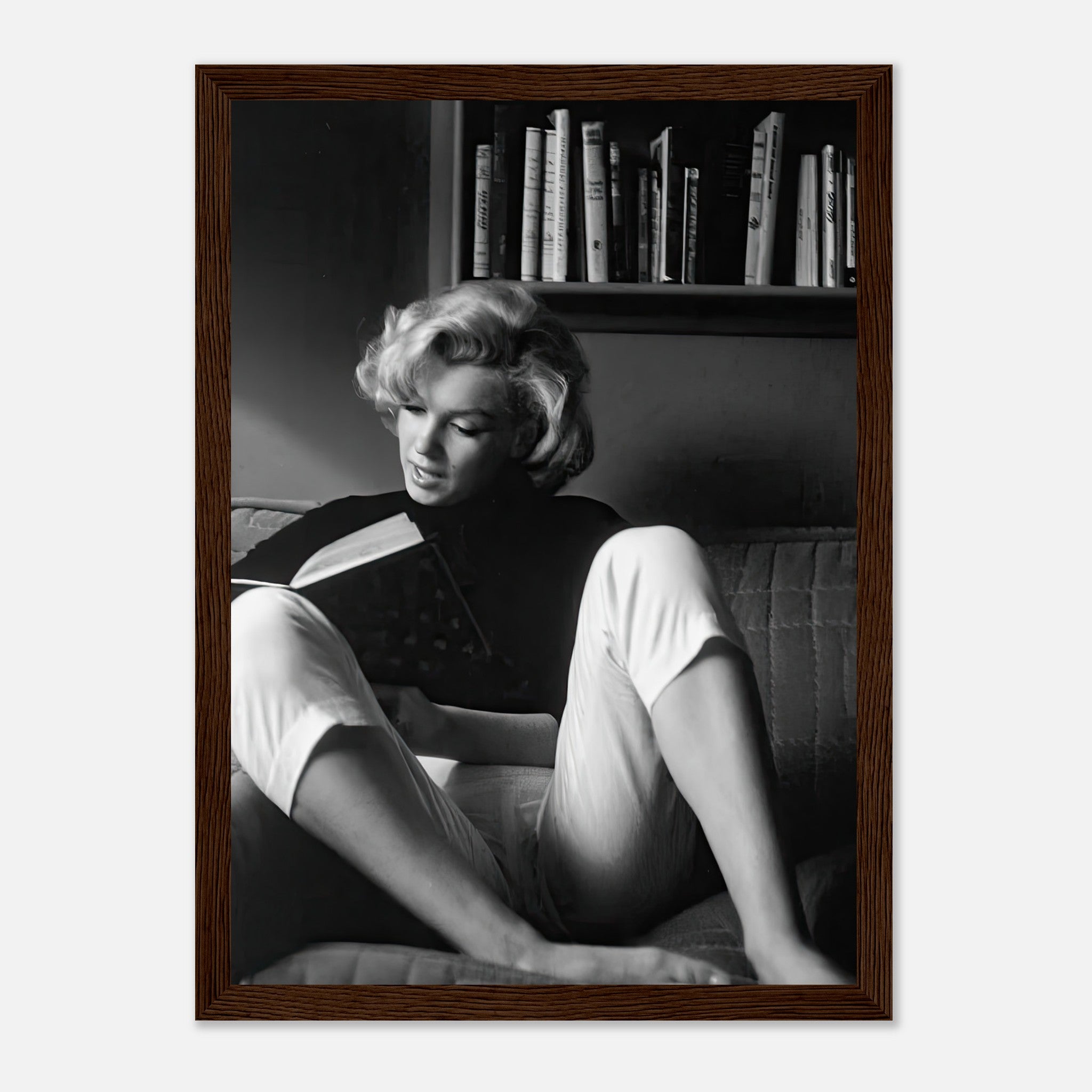 Marilyn Monroe reading at home in a black-and-white framed print, showcasing Hollywood glamour and sophistication.