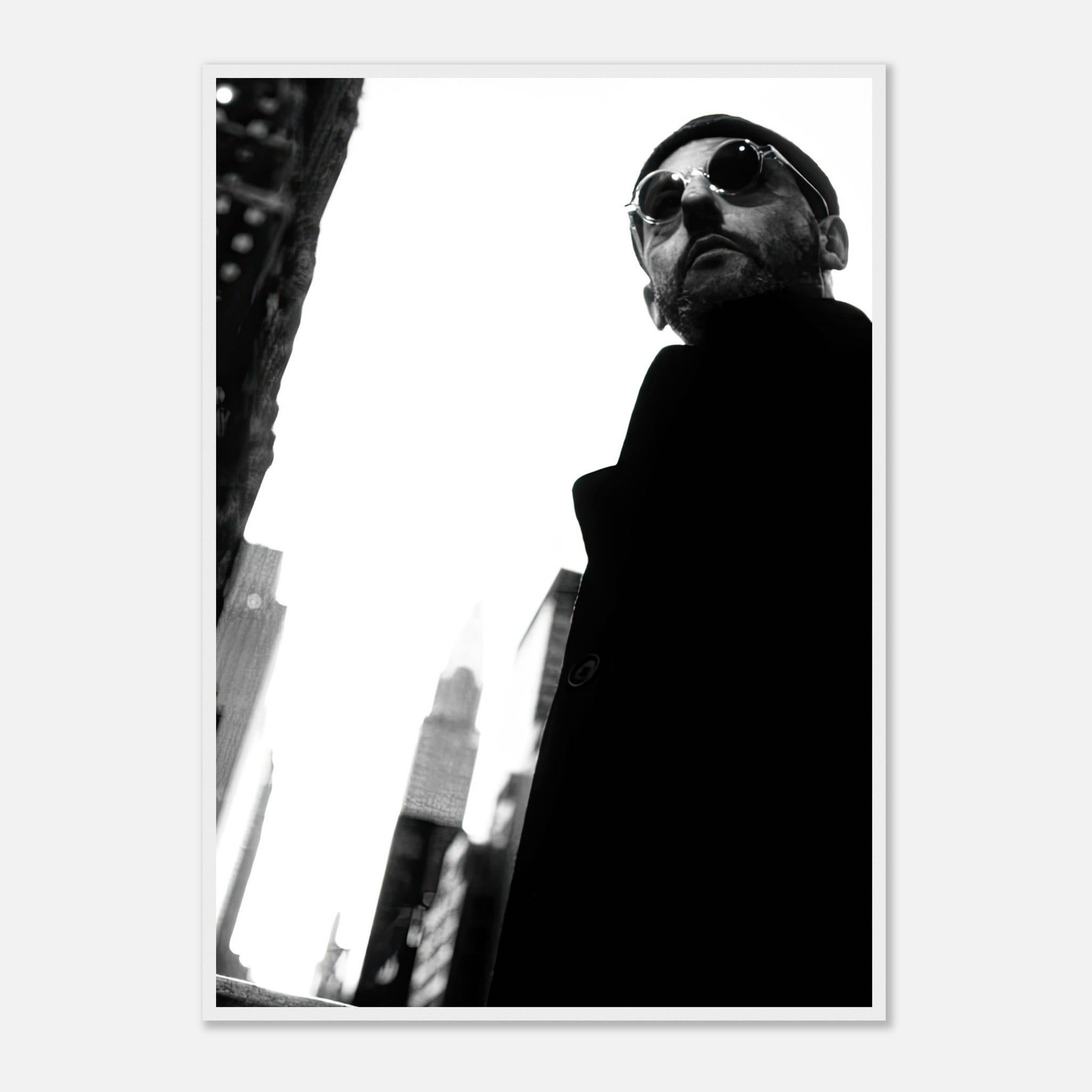 Framed print of Jean Reno in black-and-white, showcasing cinematic artistry in an urban setting.