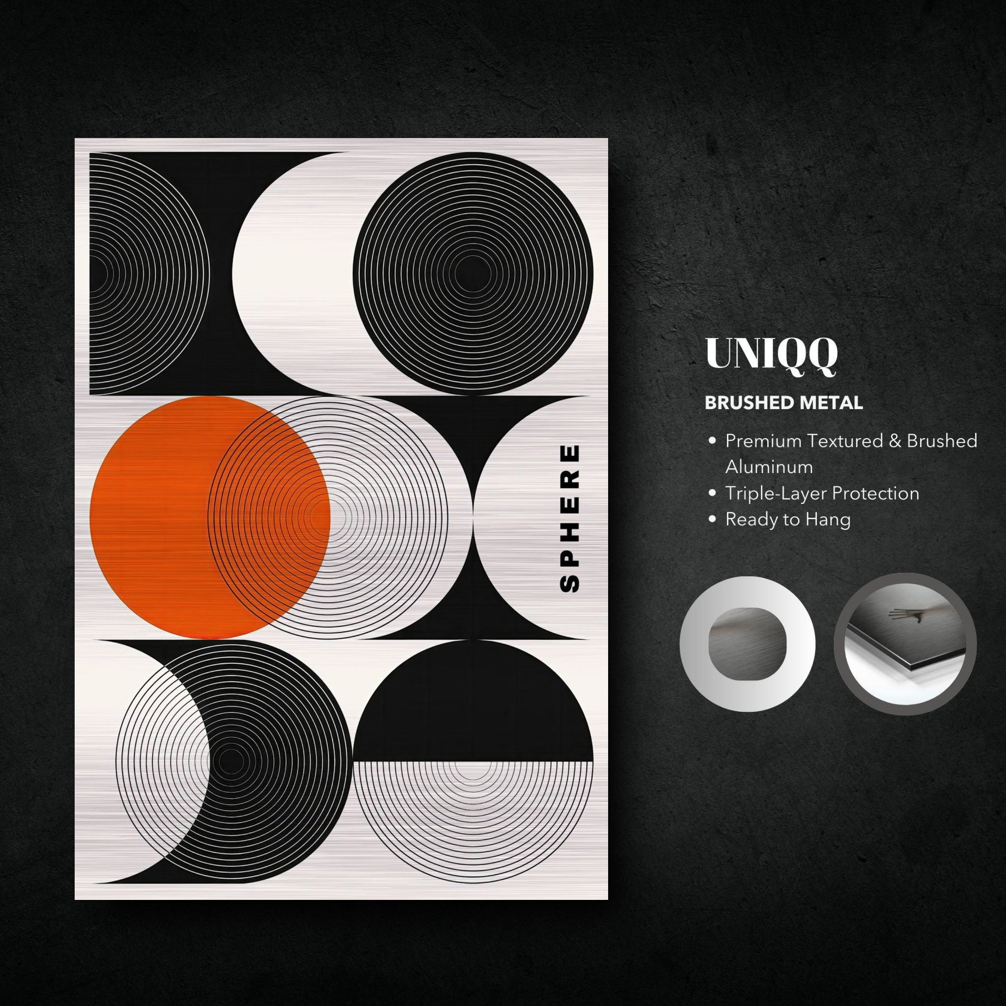 Abstract geometric sphere art in brushed metal featuring black, white, and orange circular patterns on a sleek surface.