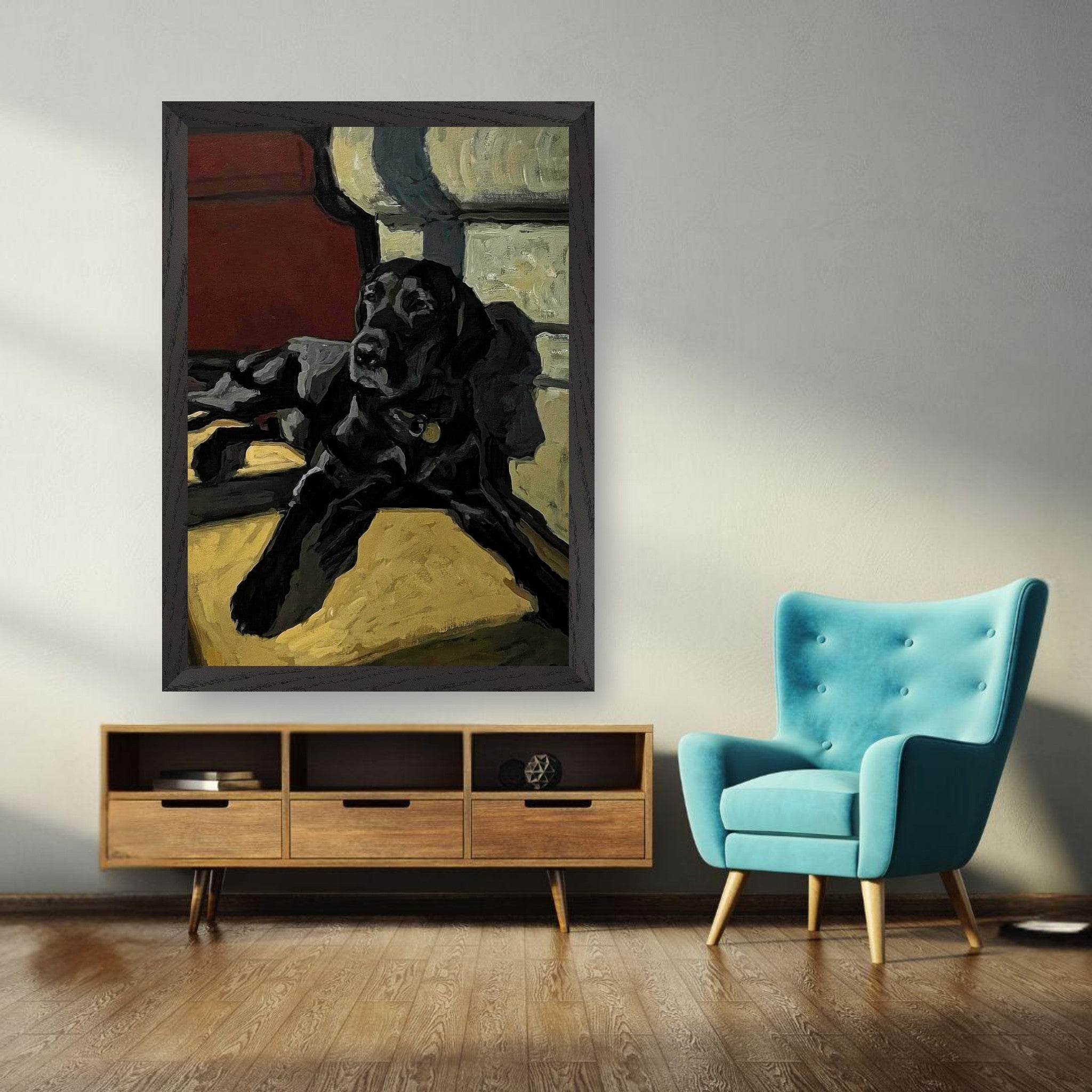 Vintage framed painting of a black Labrador dog hanging in a stylish room with a teal accent chair.