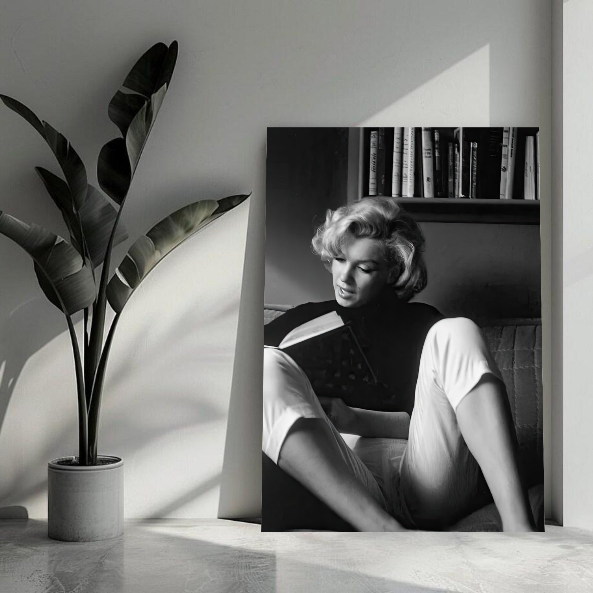 Marilyn Monroe reading at home in elegant black-and-white, showcasing timeless Hollywood grace and sophistication.