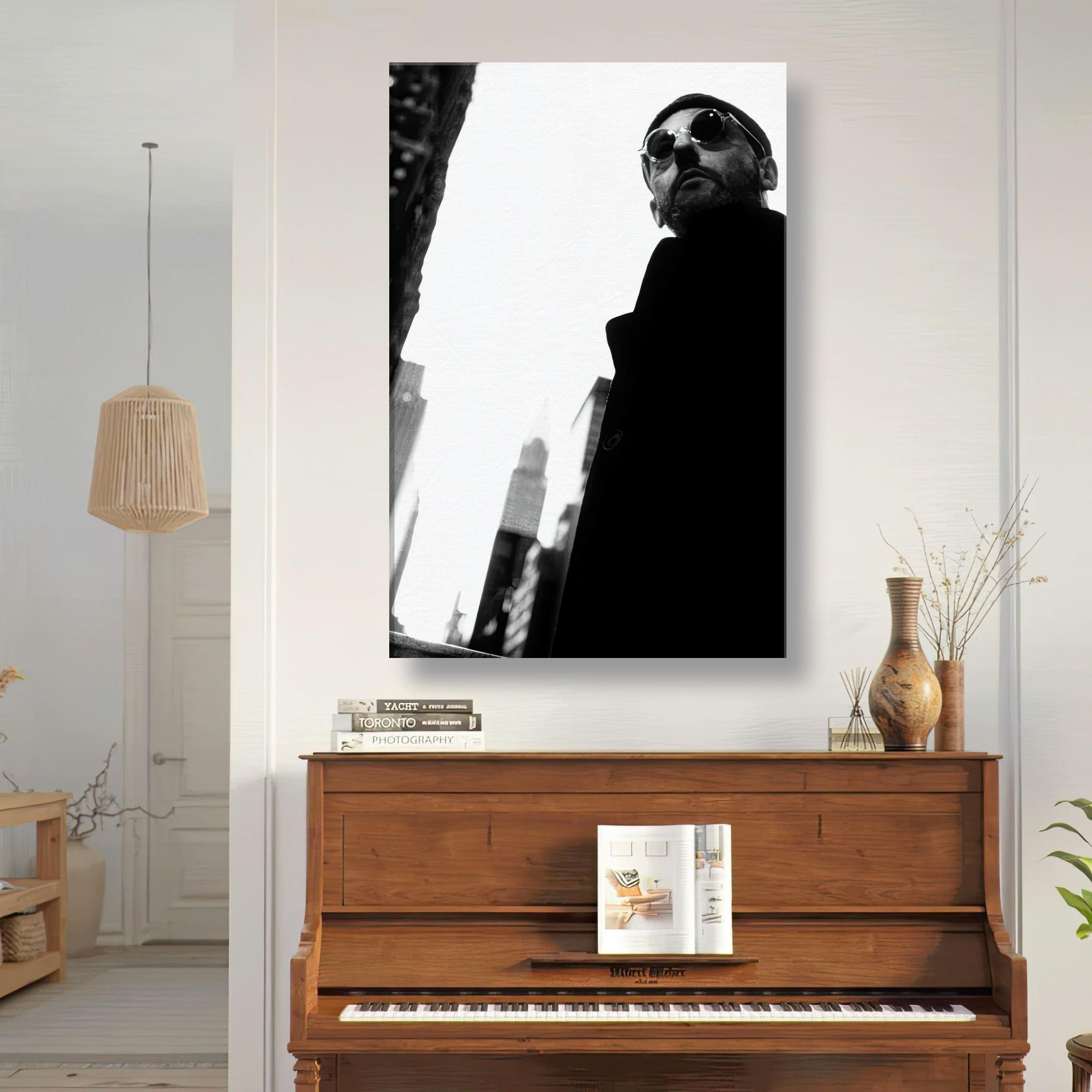 Black-and-white canvas artwork of a man in sunglasses in an urban setting, displayed above a piano.