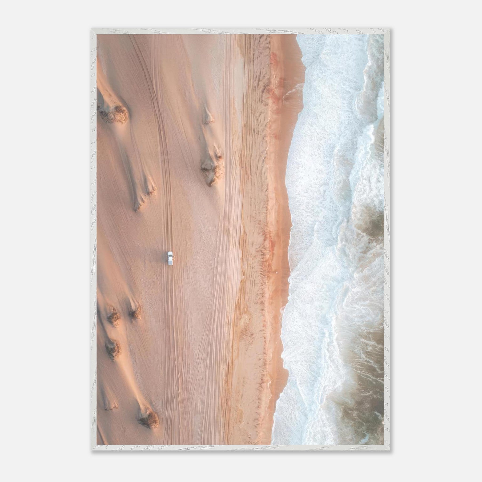 Drone photography of golden dunes meeting ocean waves, showcasing breathtaking natural contrast.