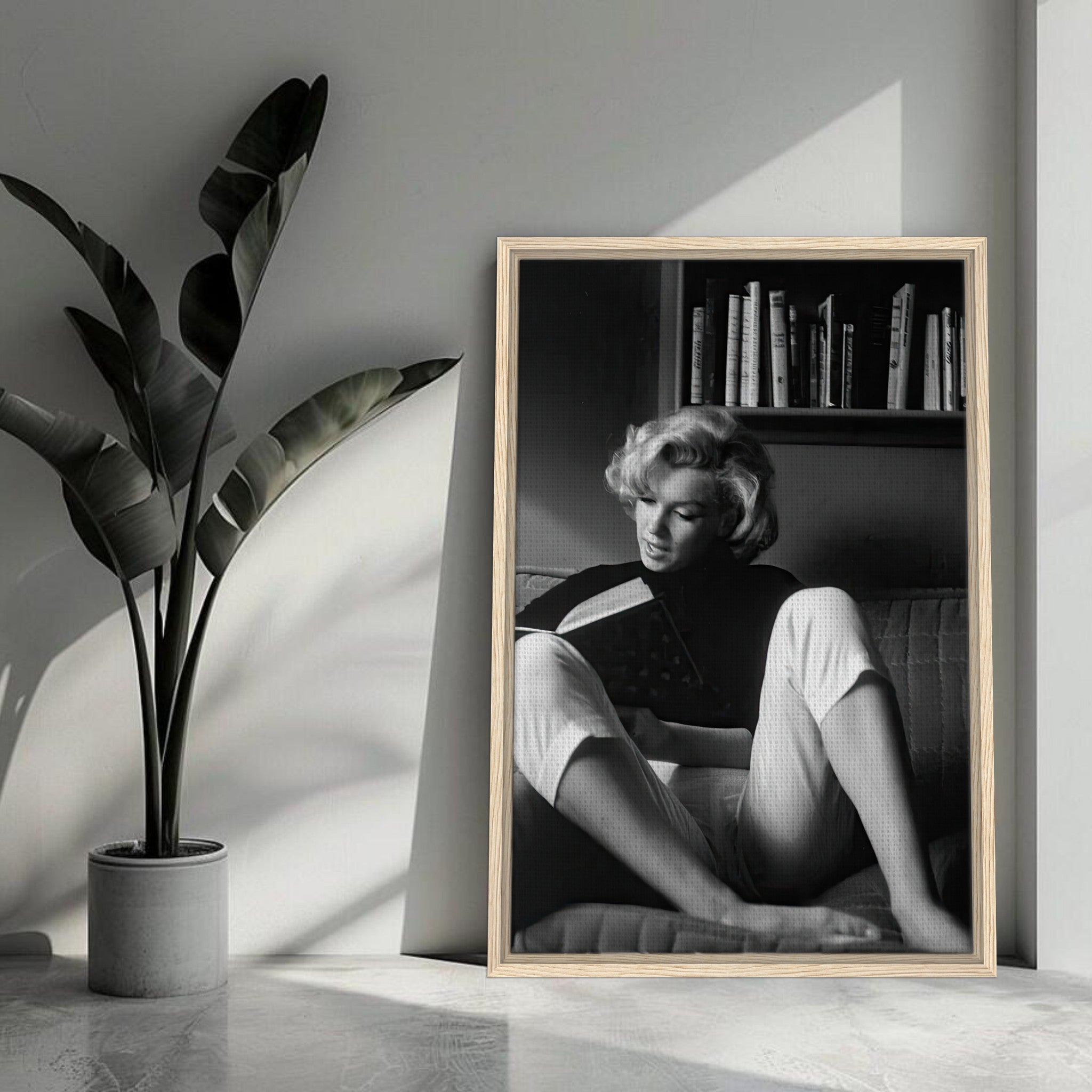 Marilyn Monroe reading at home in black-and-white, elegantly framed canvas decor for vintage-inspired interiors.