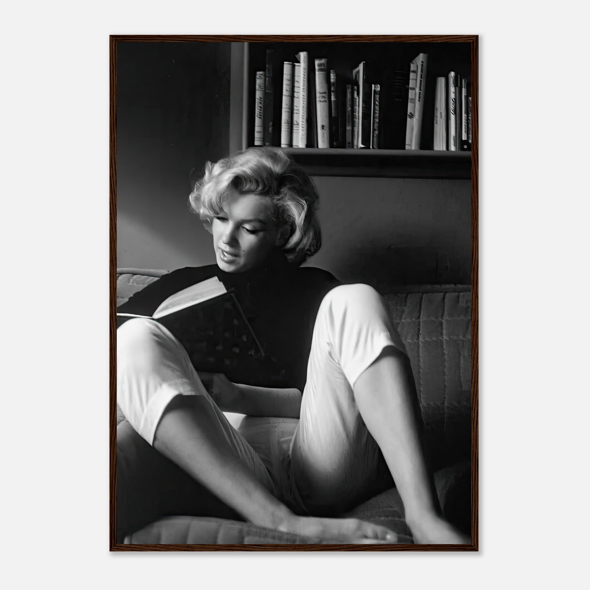 Marilyn Monroe reading at home in elegant black-and-white framed print, showcasing classic Hollywood charm.