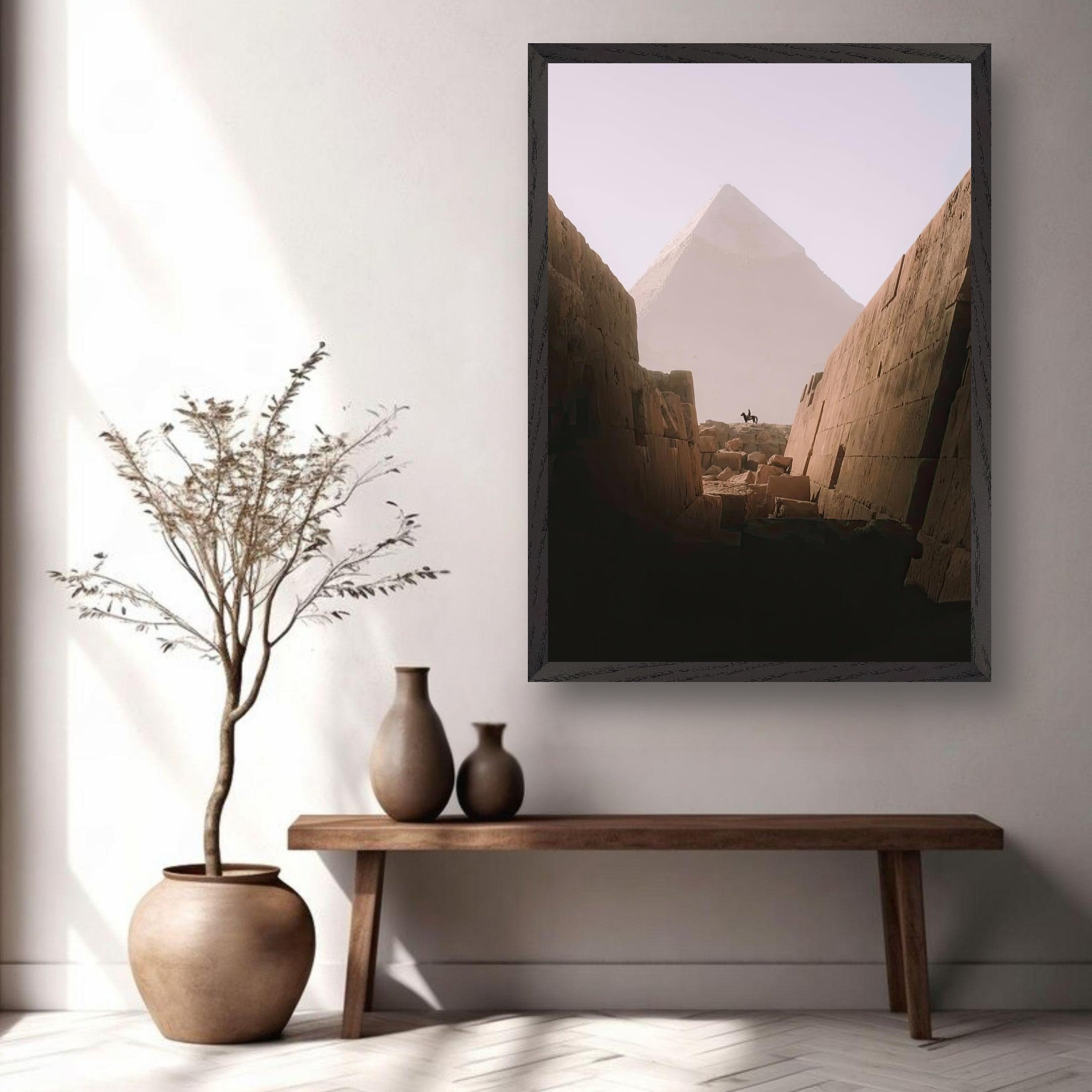 Fine art print of the Great Pyramid of Giza displayed in a modern interior setting with vases and a plant.