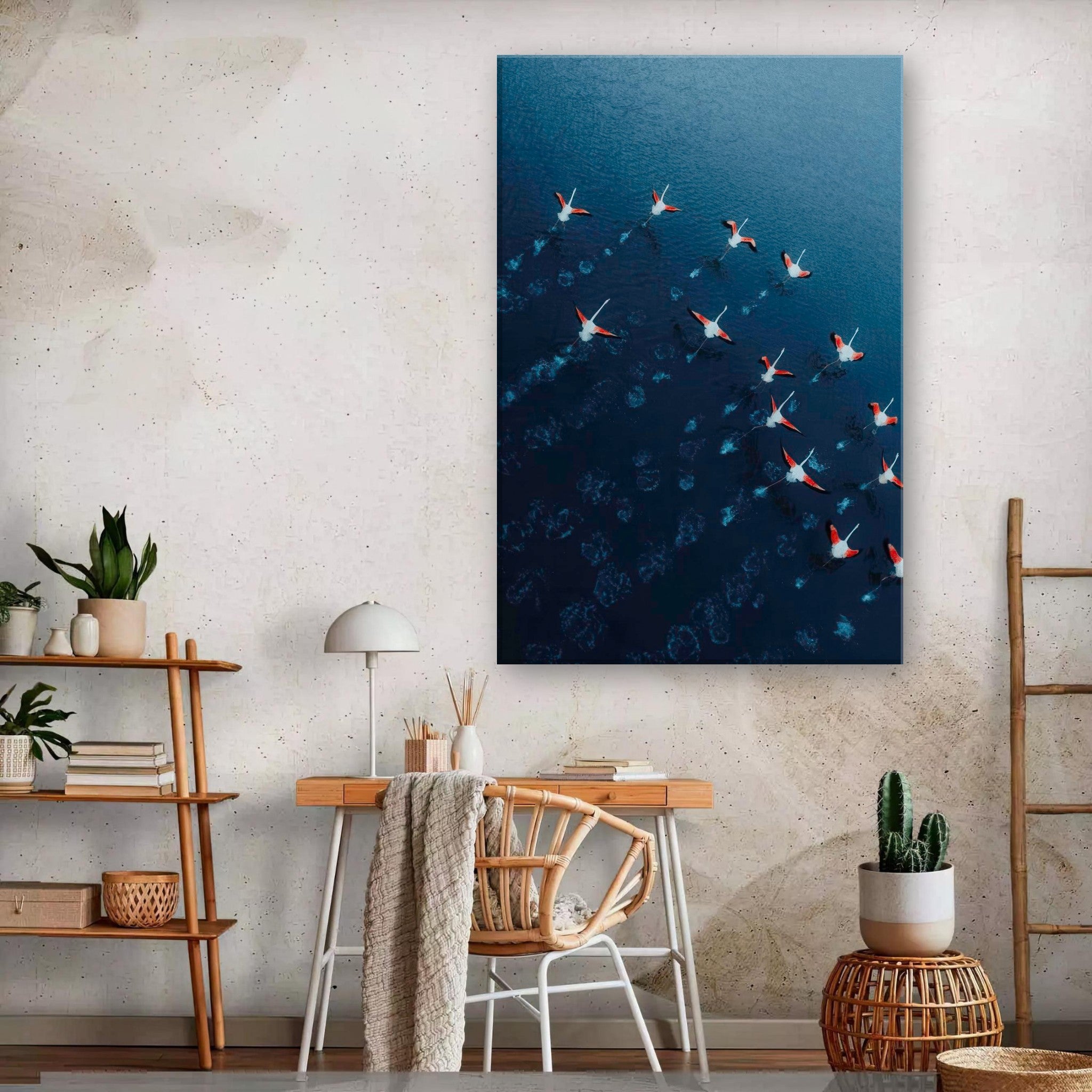 Aerial view of flamingos in flight over deep blue waters, showcased in a modern living space.