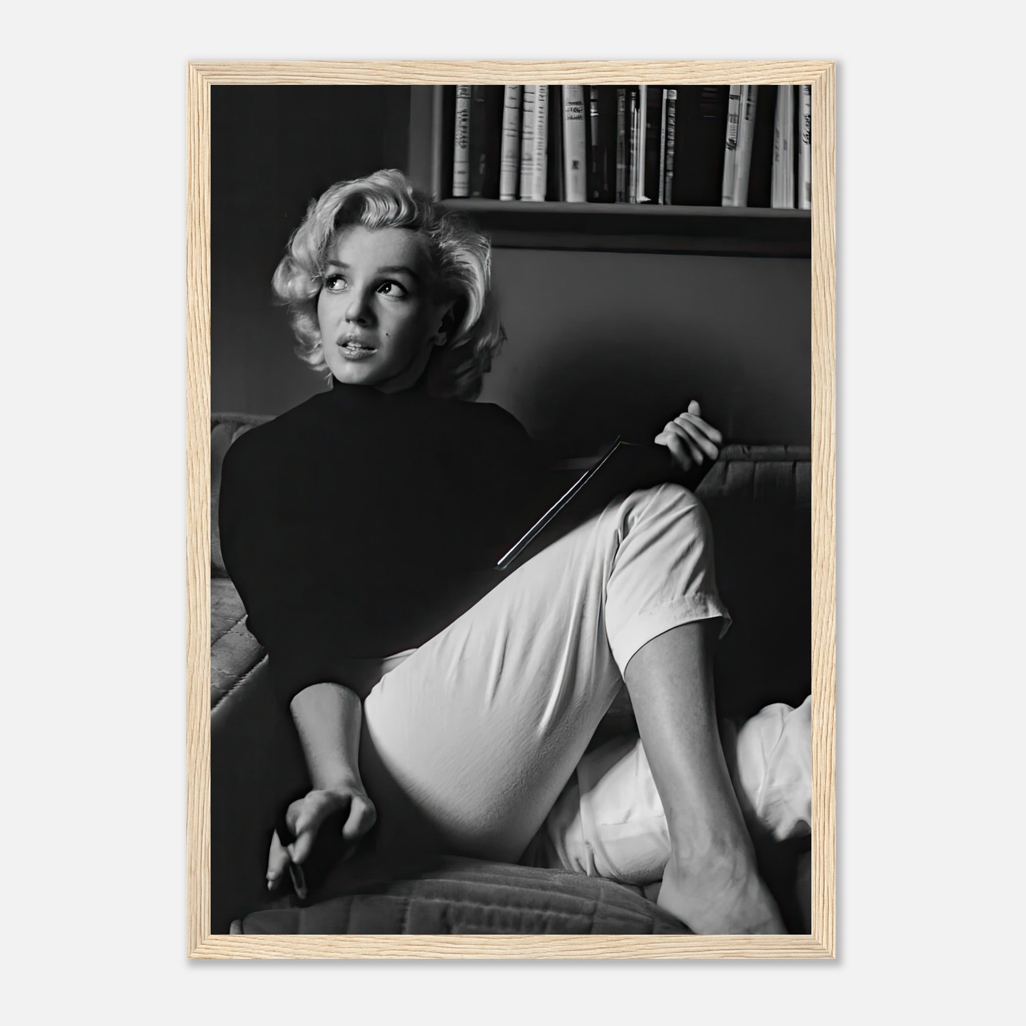 Marilyn Monroe framed print capturing her elegance while reading a book in black-and-white, perfect for home decor.