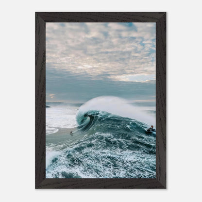 Big Wave Surfing Vintage Framed Print featuring a surfer riding a massive wave under a dramatic sky.