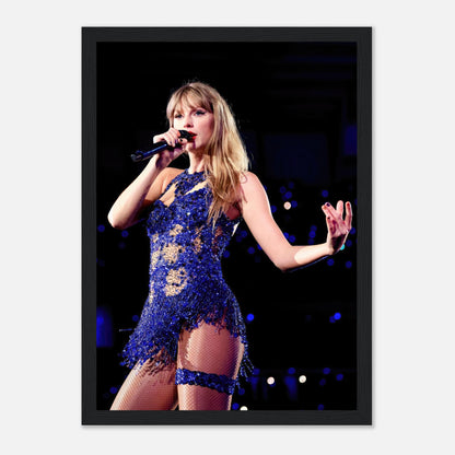 Taylor Swift performing on stage in a dazzling blue outfit, captured in a stunning framed print. Perfect for fans and music lovers.