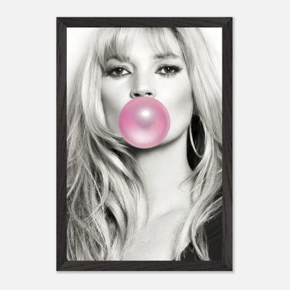 Vintage framed print of a woman with long hair blowing pink bubble gum in a black-and-white portrait.