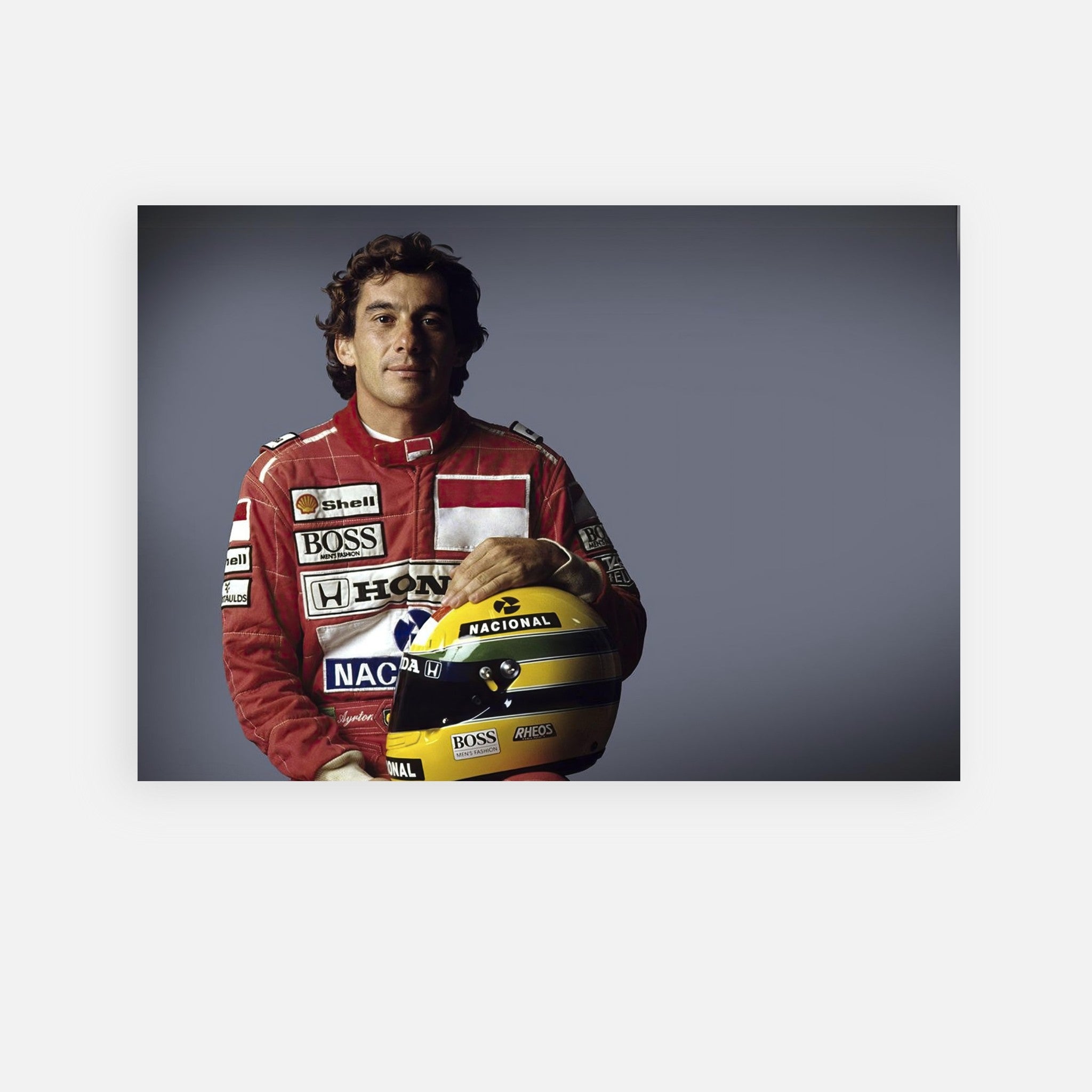 Ayrton Senna in racing gear holding his helmet, showcasing his iconic style and legacy in motorsports.