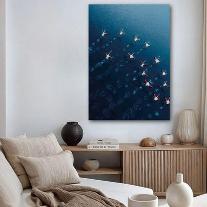 Flamingos drone photography poster showcasing vibrant flamingos over deep blue water in a stylish interior setting.