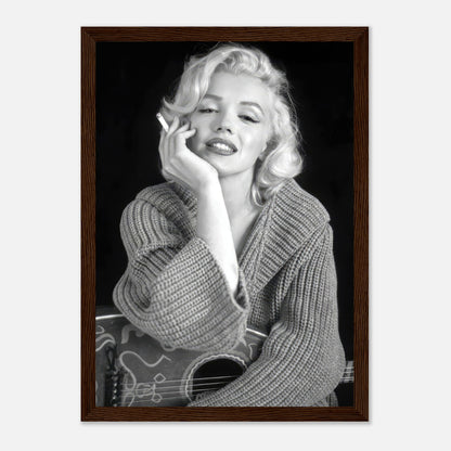 Marilyn Monroe smoking in a cozy knit sweater, captured in a classic black-and-white framed poster.