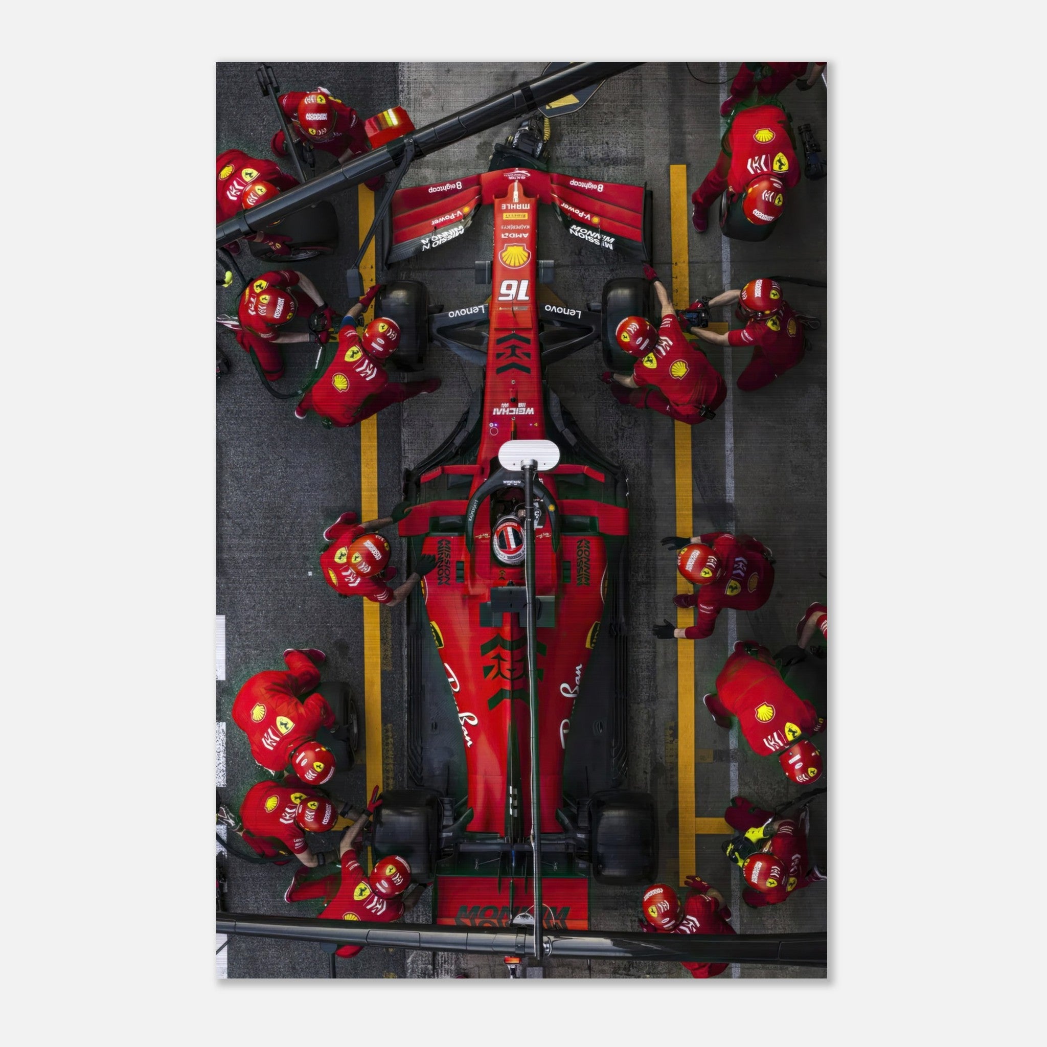 Brushed metal print of Ferrari pitstop, showcasing dynamic Formula 1 action and vibrant team colors.