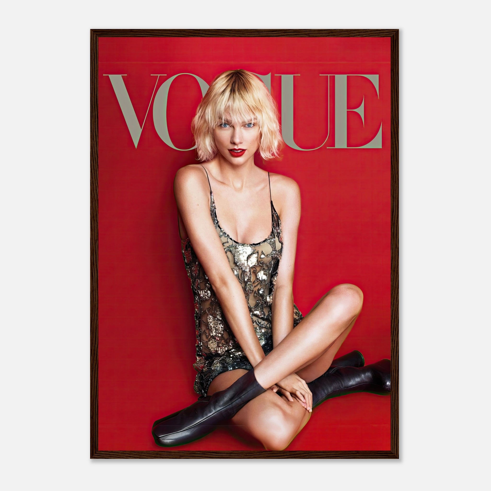 Taylor Swift Vogue Framed Poster featuring a striking red backdrop and metallic sequined dress, exuding elegance and confidence.