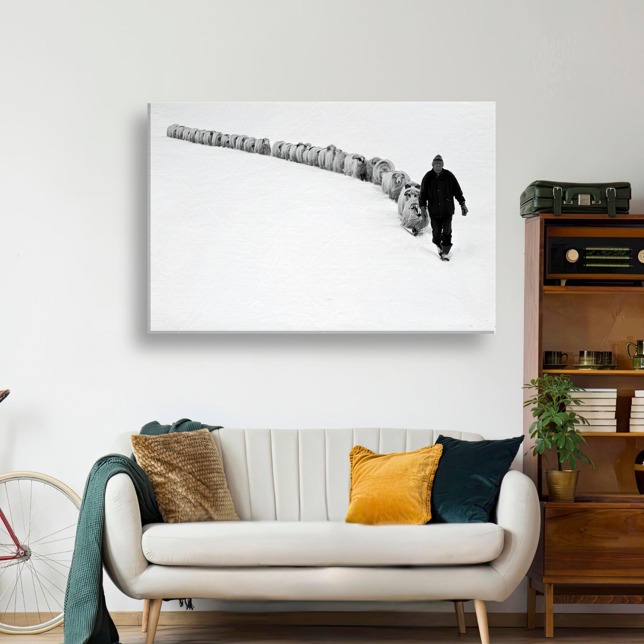 Black-and-white canvas print of shepherd guiding sheep through a snowy landscape, symbolizing tradition and resilience.