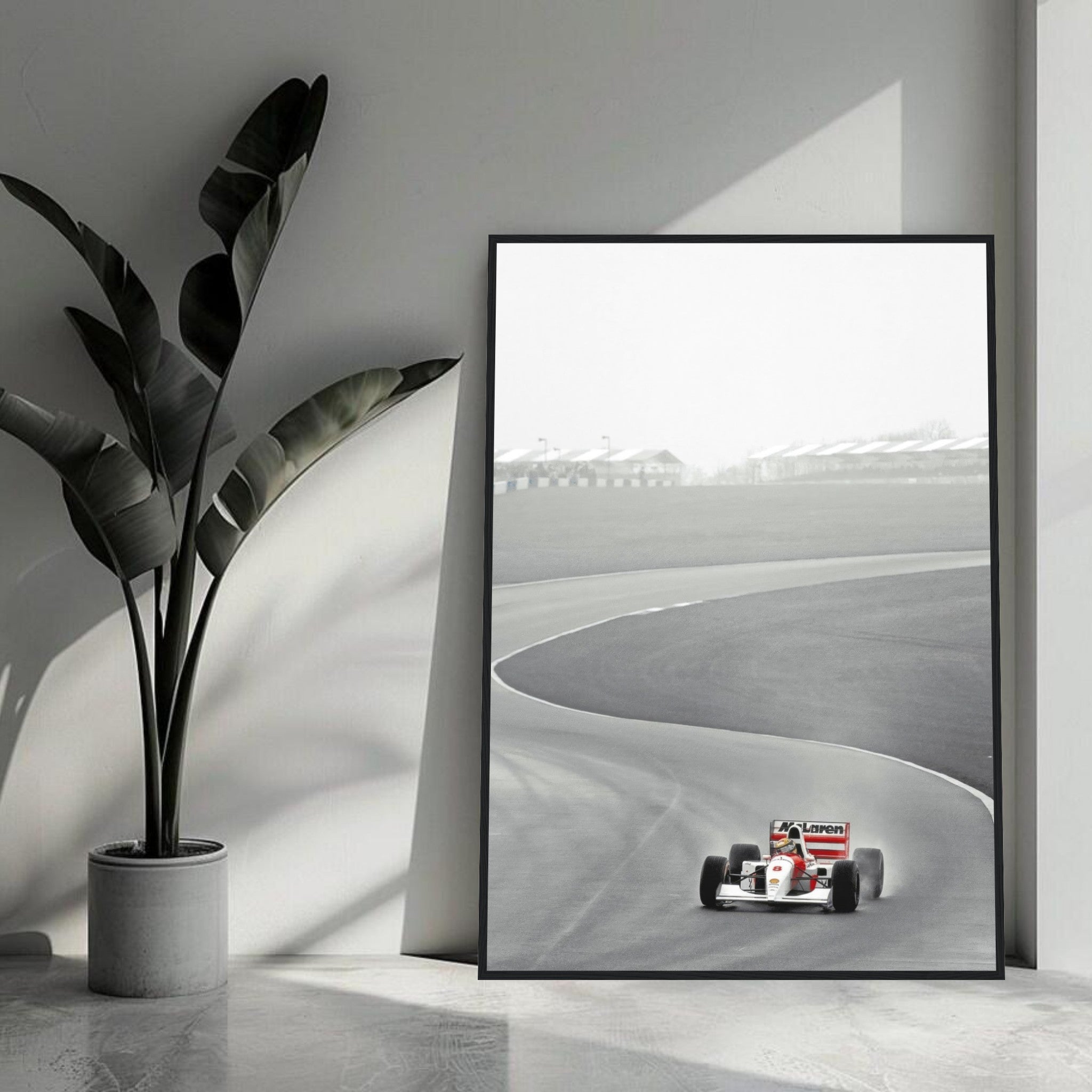 Ayrton Senna driving McLaren MP4/4 in 1988 framed print, showcasing iconic racing moment in black and white.