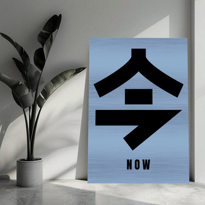 Japanese Kanji for 'Now' in bold black on modern brushed metal background, enhancing a chic living space.