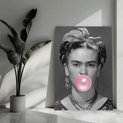 Frida Kahlo metal print featuring a black-and-white portrait and a pink bubble gum accent, enhancing modern decor.