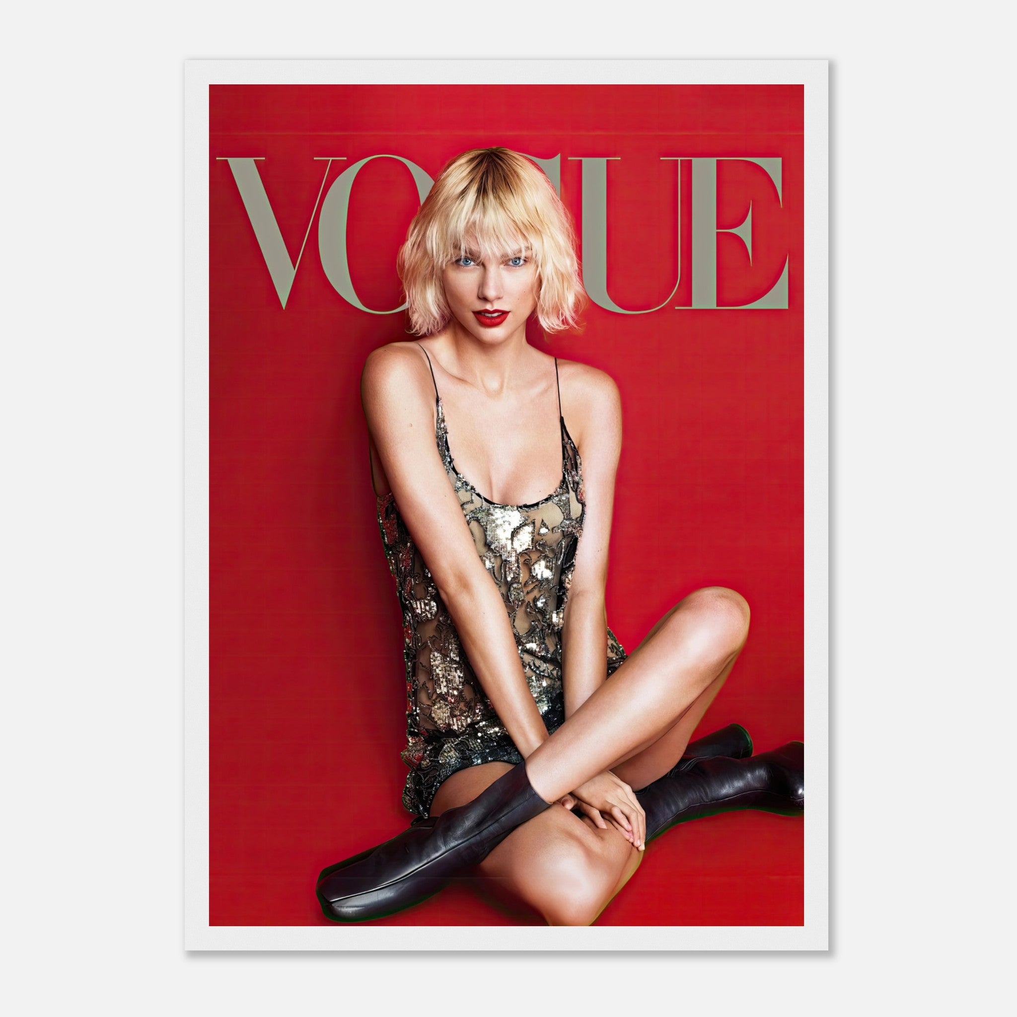 Taylor Swift Vogue framed poster featuring her in a metallic dress against a striking red backdrop, exuding elegance and confidence.