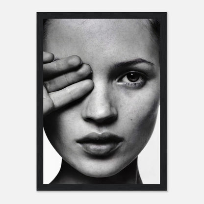 Black and white framed print of a woman covering one eye, showcasing striking monochromatic portrait and elegant design.