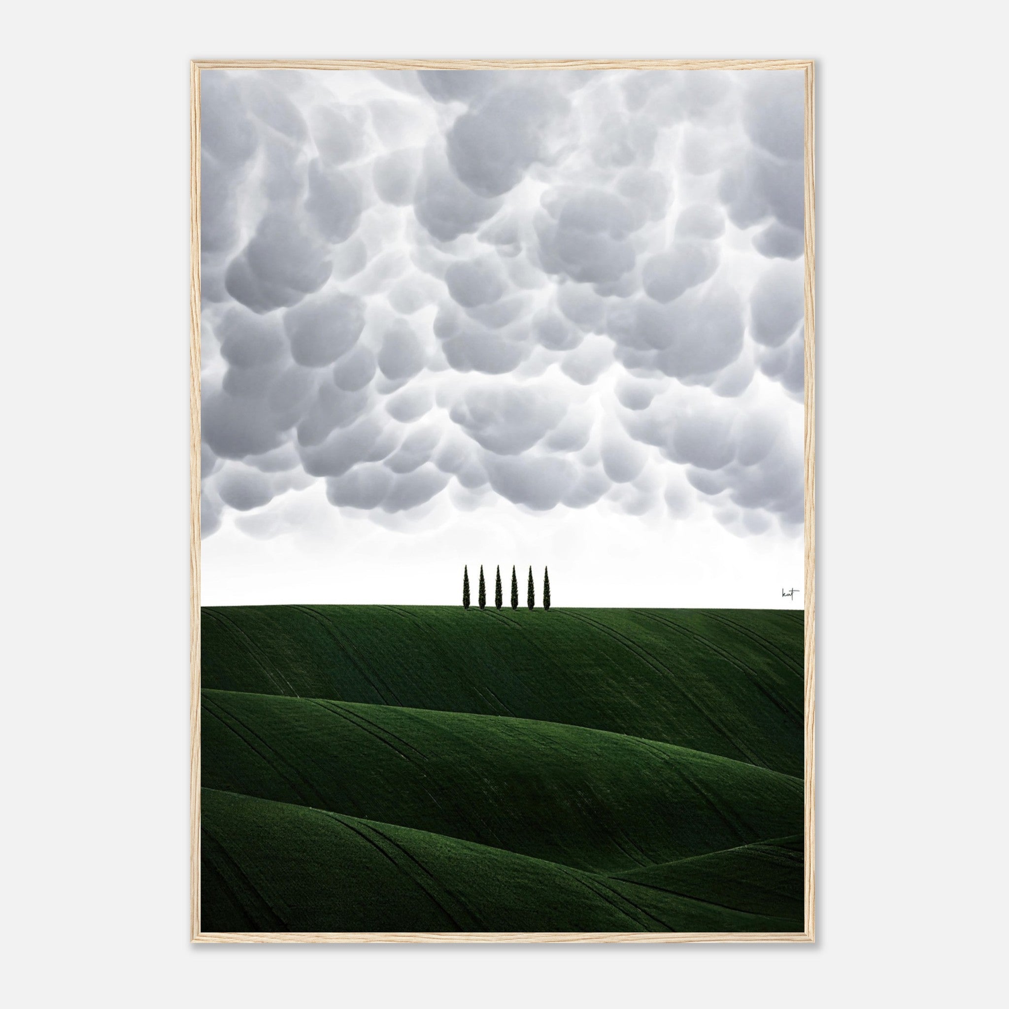 Toscana framed print featuring rolling green hills, cypress trees, and dramatic clouds, capturing the essence of Italy's countryside.