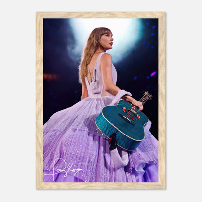 Taylor Swift framed poster featuring her in a lavender gown holding a blue guitar under a spotlight.