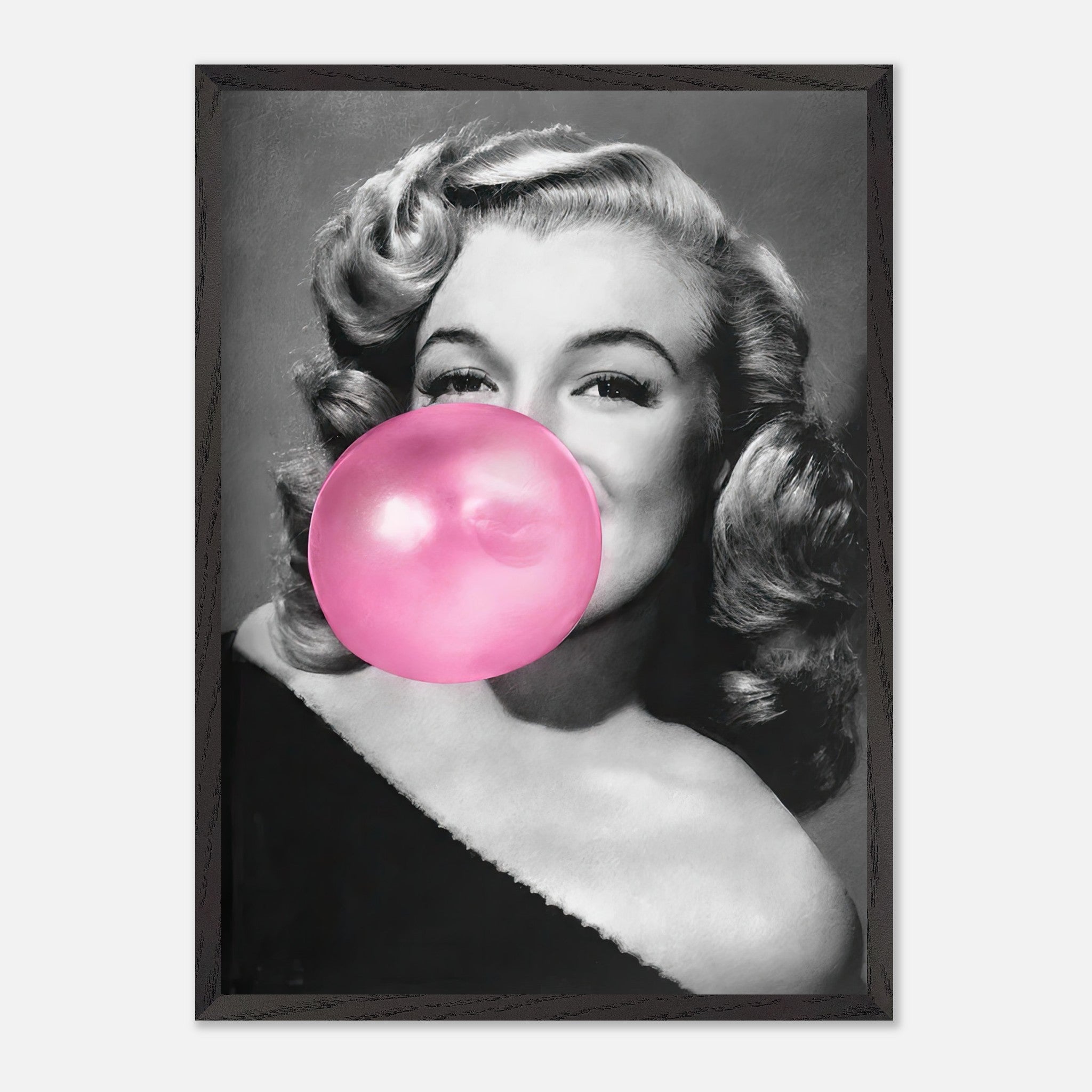 Vintage framed print of Marilyn Monroe blowing a pink bubble gum, adding a playful touch to wall decor.