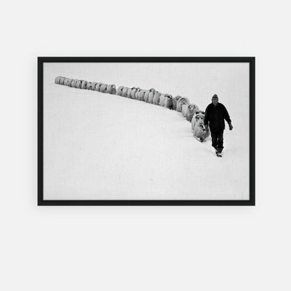 Black-and-white framed print of a shepherd leading sheep through a snowy landscape, symbolizing resilience and tradition.