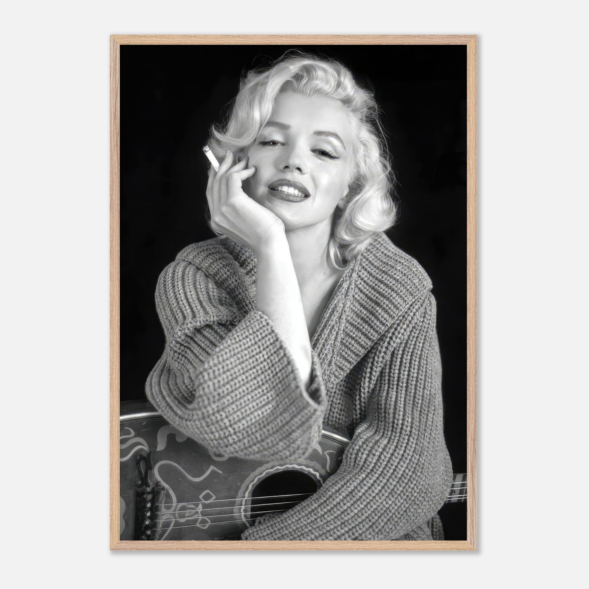 Marilyn Monroe smoking in a cozy knitted sweater, captured in a timeless vintage black-and-white framed print.