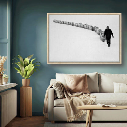 A lone shepherd walks through a snow-covered landscape with his flock in a framed canvas print, capturing rural serenity.