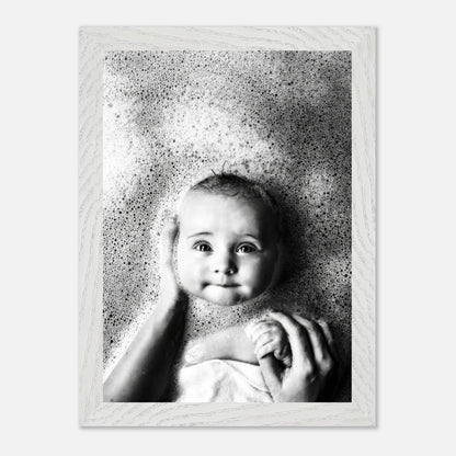 Vintage black and white photograph of a baby in a bubble bath, showcasing innocence and nostalgia.