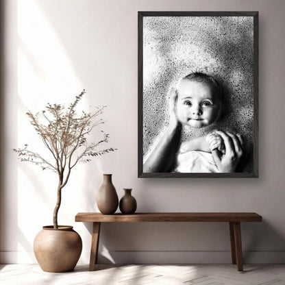 Museum-quality black-and-white fine art print of a baby enjoying bath time, surrounded by soft bubbles.
