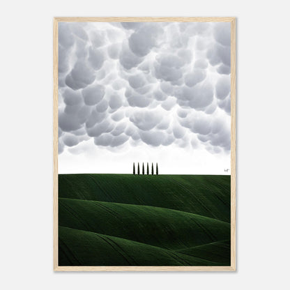 Toscana Italy framed print featuring rolling green hills and cypress trees under dramatic clouds.