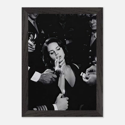 Lana Del Ray smoking in a vintage black-and-white framed print, surrounded by admirers, exuding timeless elegance.