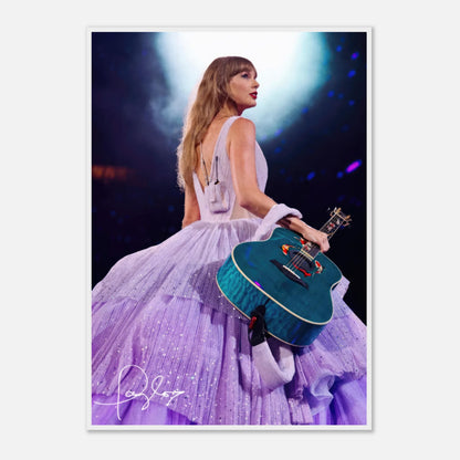 Taylor Swift Framed Poster in lavender gown holding a guitar, capturing her iconic stage presence and dazzling performance.