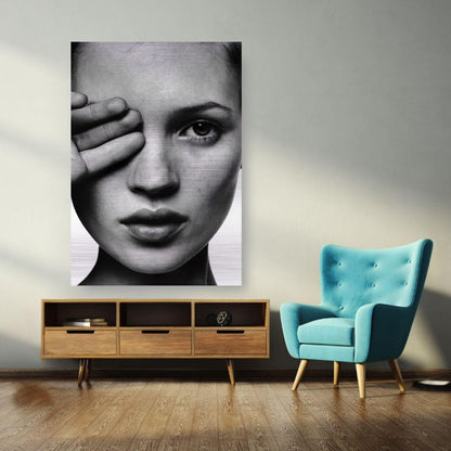 Kate Moss black and white portrait on brushed metal displayed in a modern living room setting.