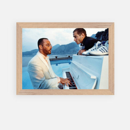 Vintage framed print of Jean Reno playing piano on a seaside set from "The Big Blue" film.