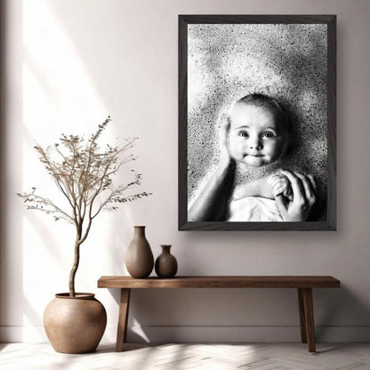 Vintage framed print of a baby smiling in bubbles, showcasing timeless childhood innocence in a serene black and white photograph.