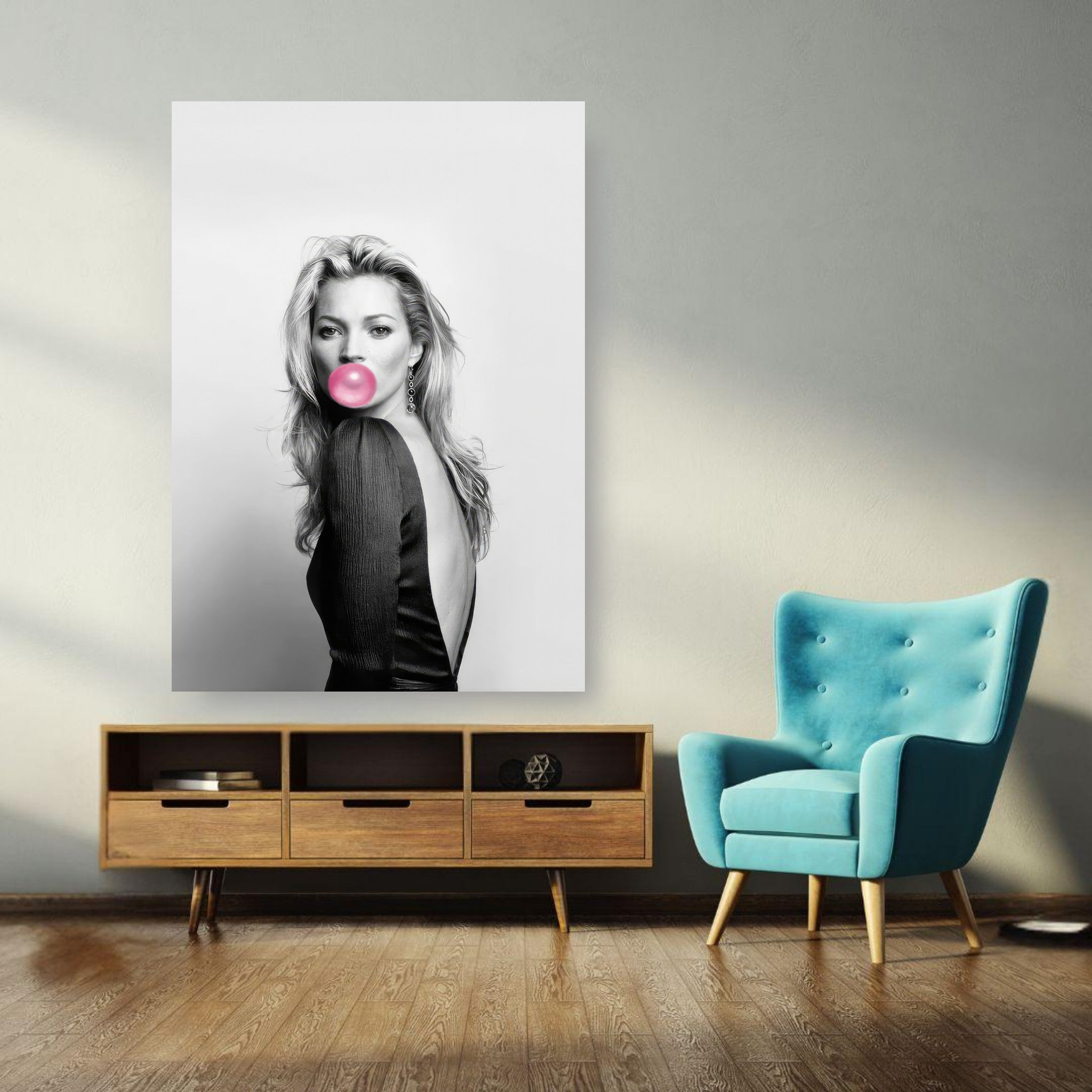 Black-and-white poster of Kate Moss blowing bubble gum, adding chic flair to a modern interior.