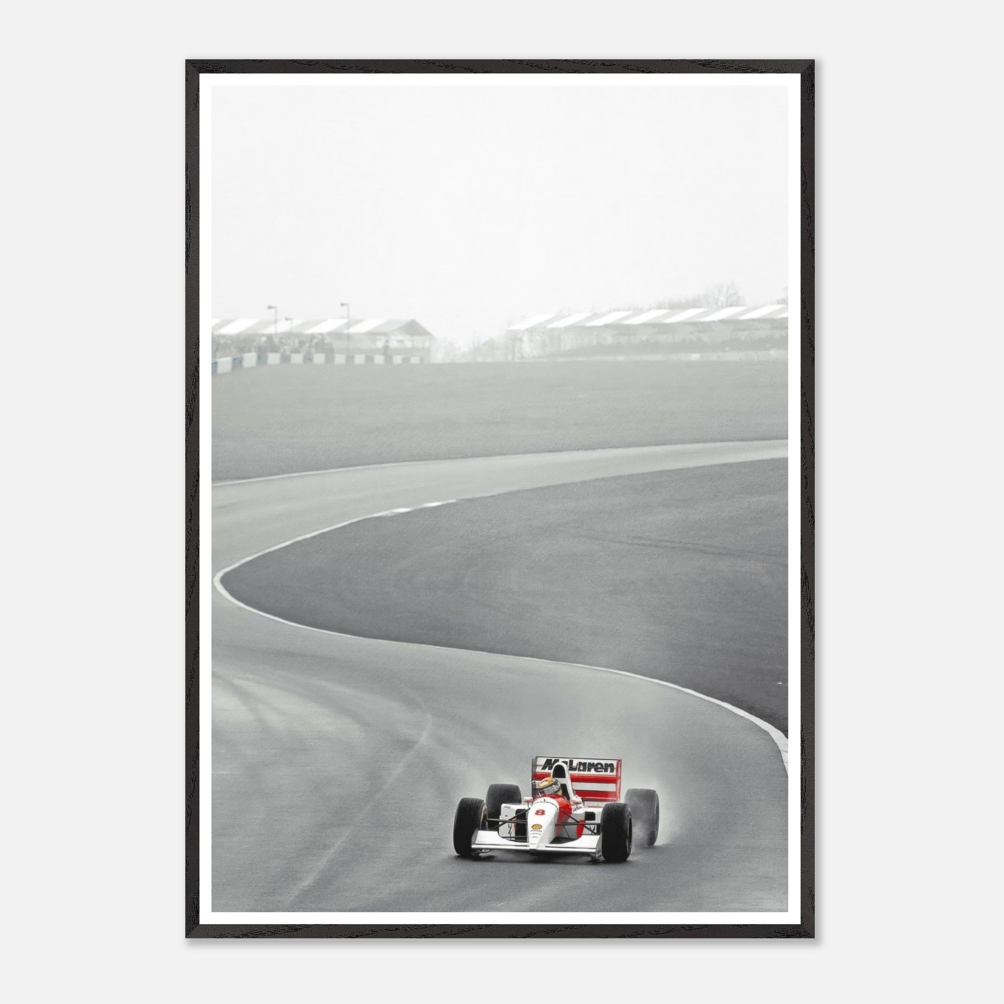 Framed giclée fine art print of Ayrton Senna racing in a McLaren MP4/4 on a curved track, showcasing speed and precision.