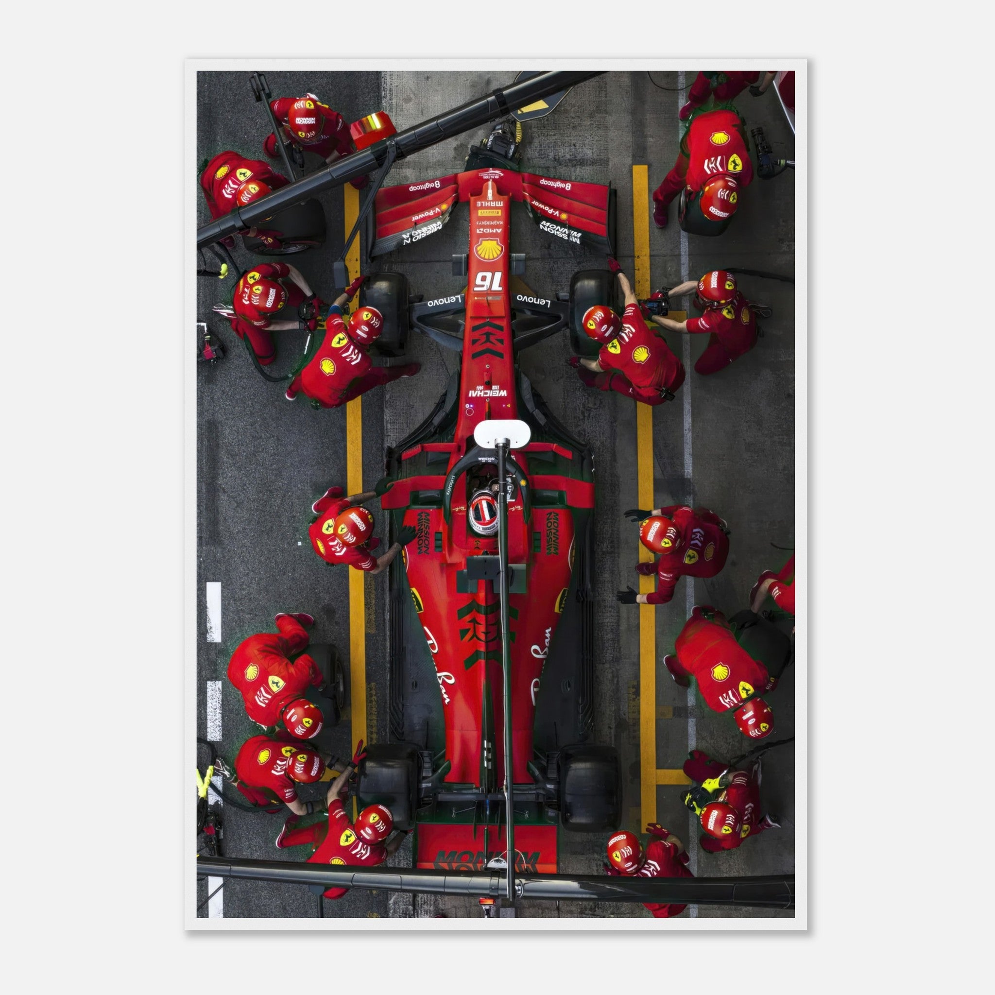 Aerial view of a Ferrari F1 pitstop, showcasing the vibrant red car and a skilled pit crew in action.