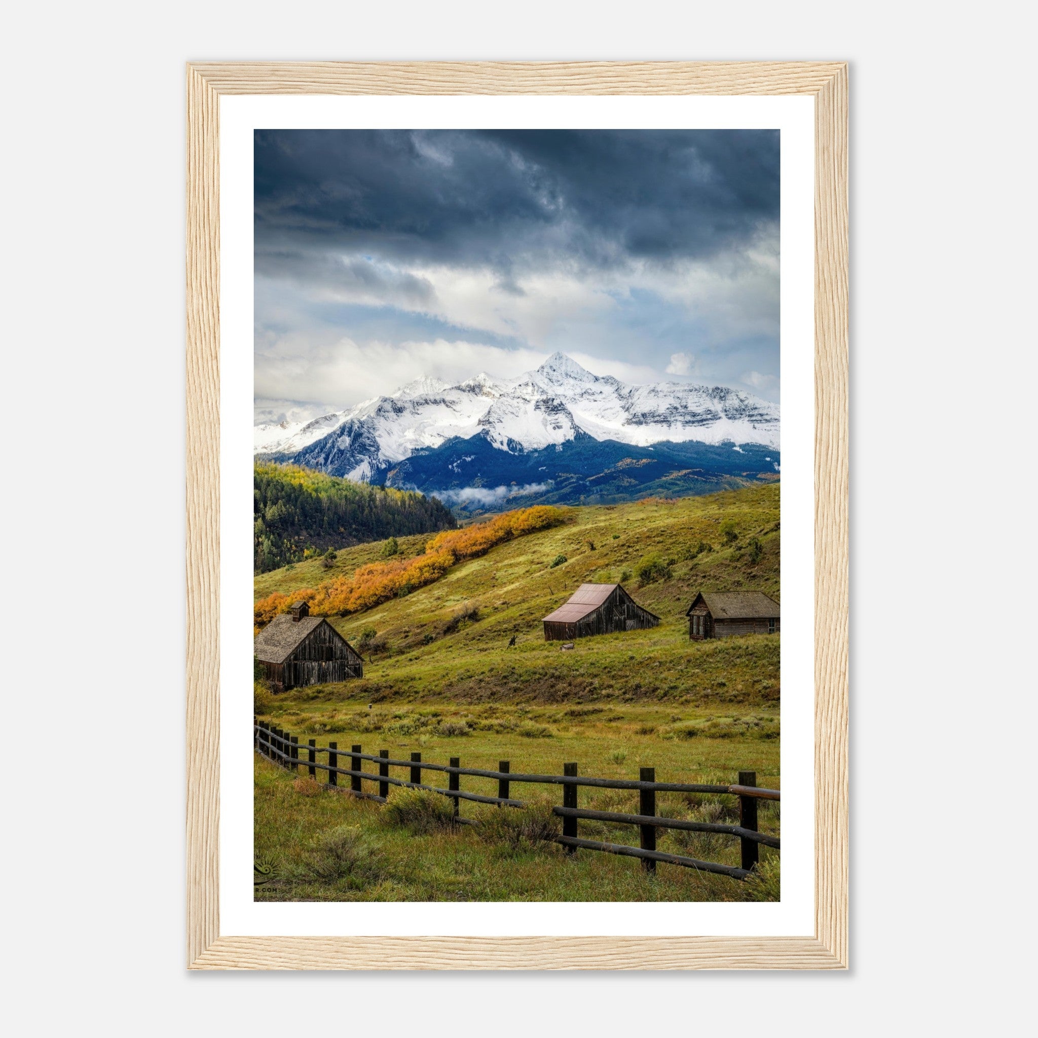 Framed print of Telluride, Colorado showcasing snow-capped mountains, rustic barns, and vibrant meadows.