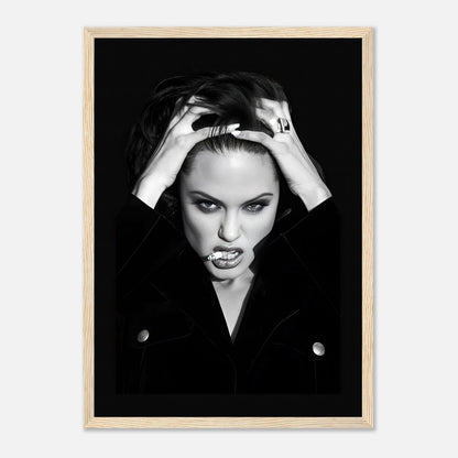 Black-and-white framed print of a glamorous woman with bold expressions and stylish attire.