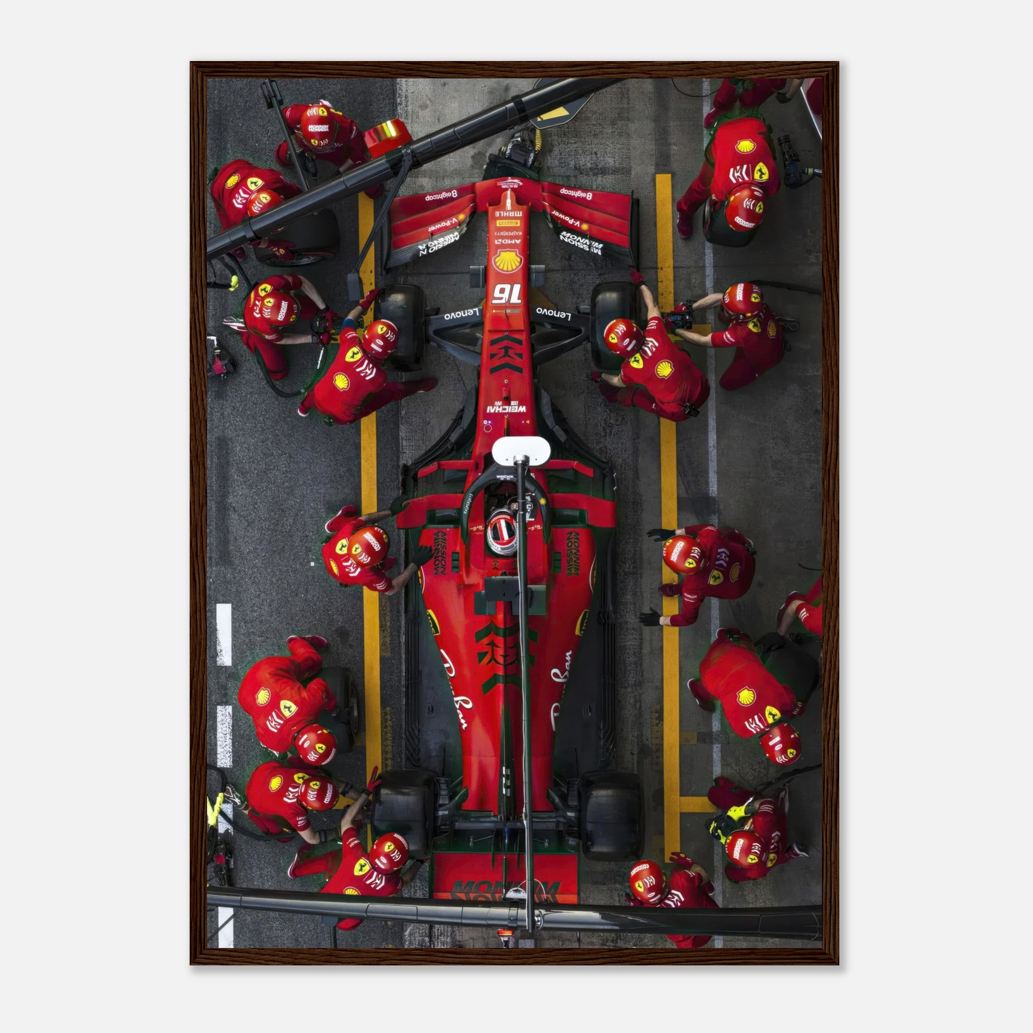 Dynamic Formula 1 pitstop framed print featuring Ferrari and pit crew in action, capturing the thrill of motorsport.