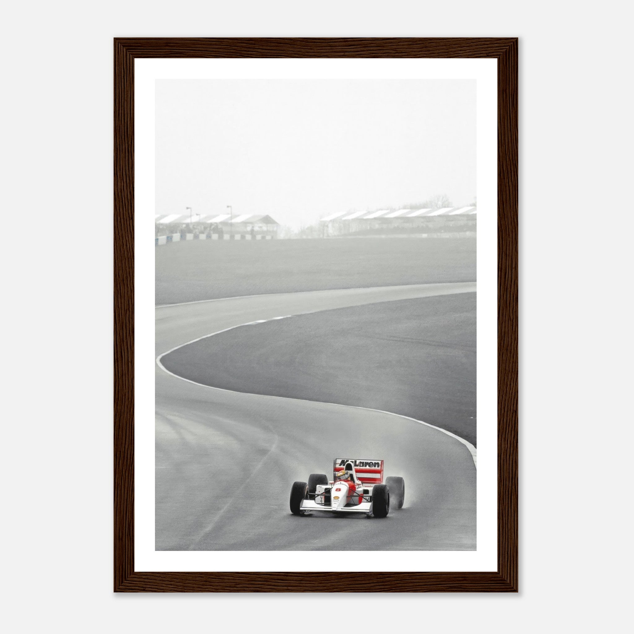 Framed print of Ayrton Senna in the 1988 McLaren MP4/4 racing around a track in black and white photography.