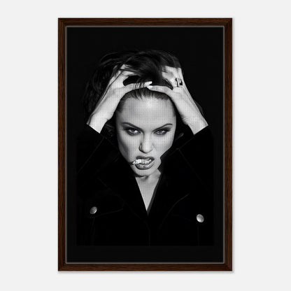 Framed canvas print of Angelina Jolie exuding elegance and rebellion with bold expression, perfect for home decor.